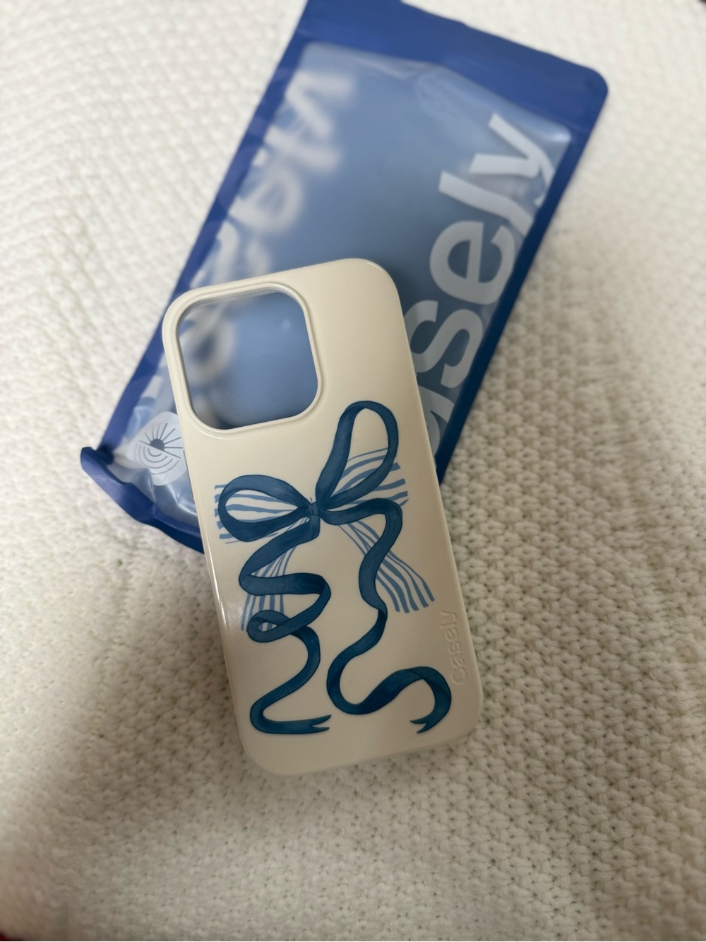 Casetify Cream Phone Case with Blue Ribbon Graphic